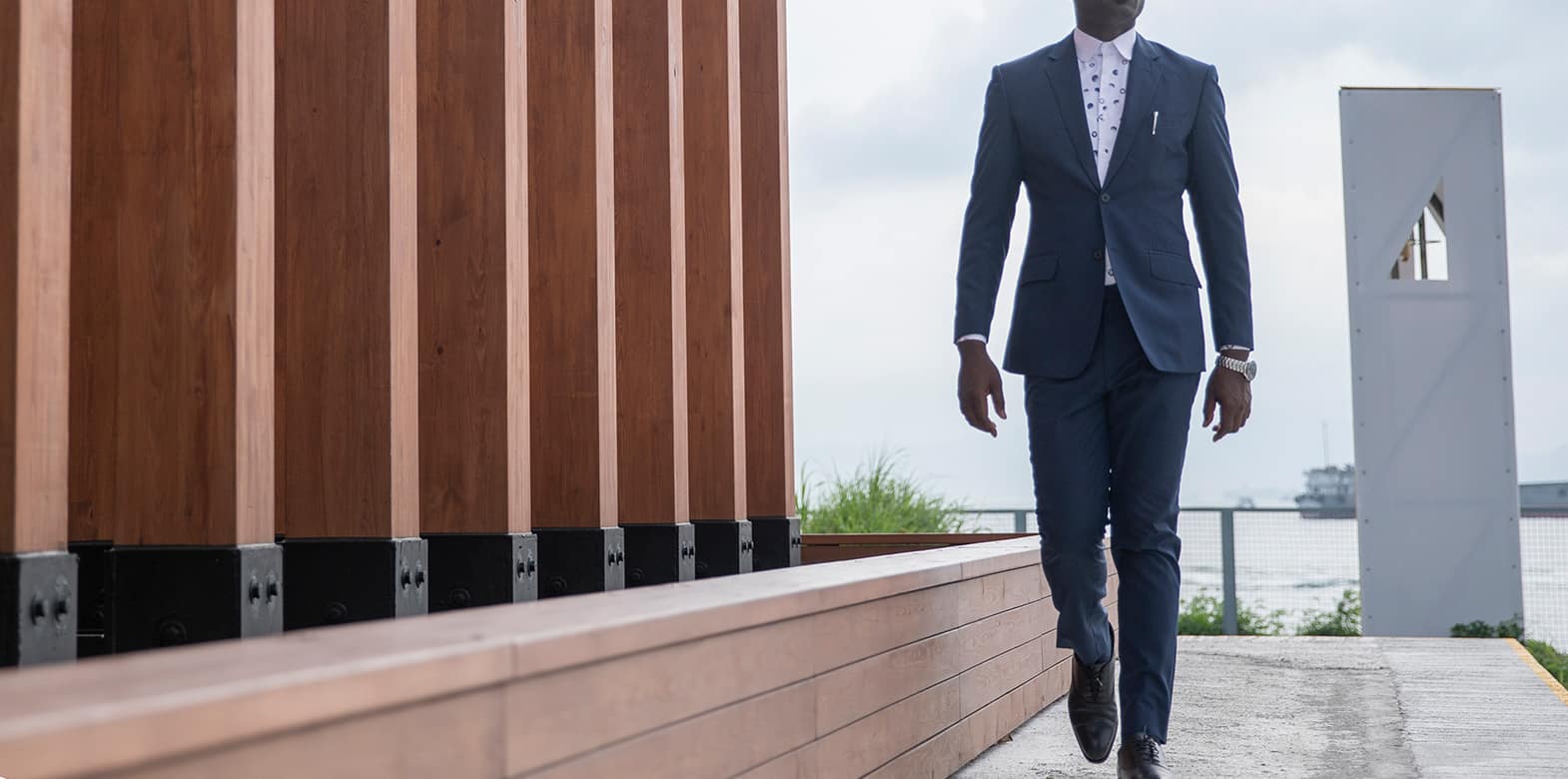 custom made blue suit with polka dot shirt by Ghanaian tailor